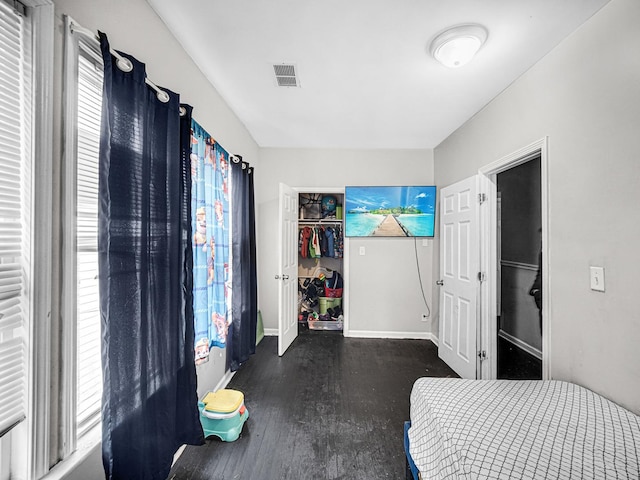 bedroom with a closet and dark wood-type flooring