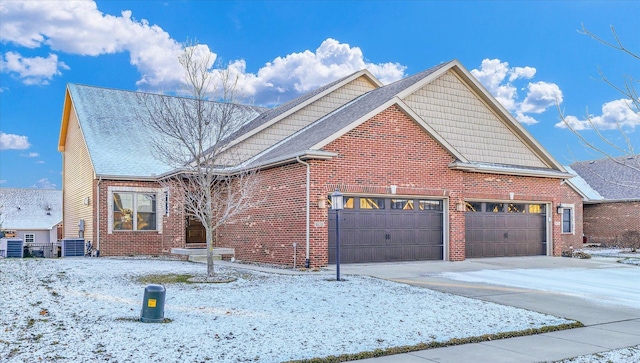 view of front of house with central AC and a garage