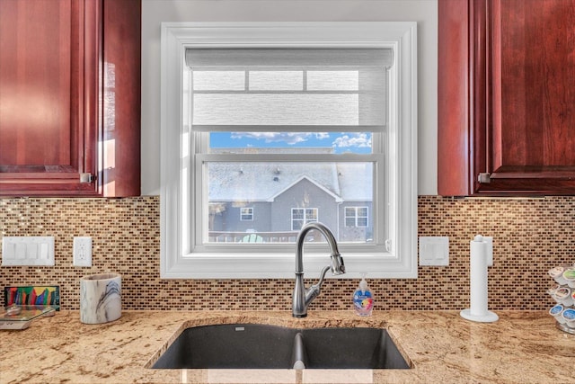 kitchen featuring sink, backsplash, and a wealth of natural light