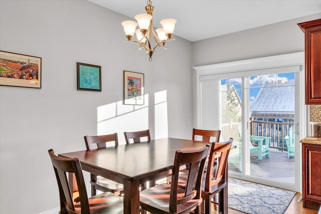 dining area featuring light hardwood / wood-style floors and a chandelier