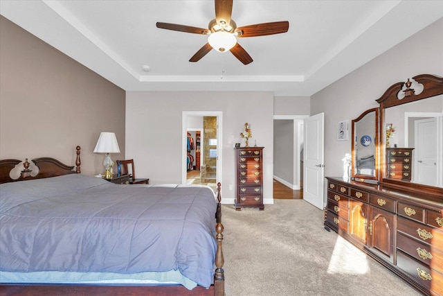 carpeted bedroom with ceiling fan and ensuite bath