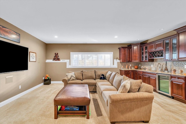 living room featuring light colored carpet, beverage cooler, and indoor wet bar