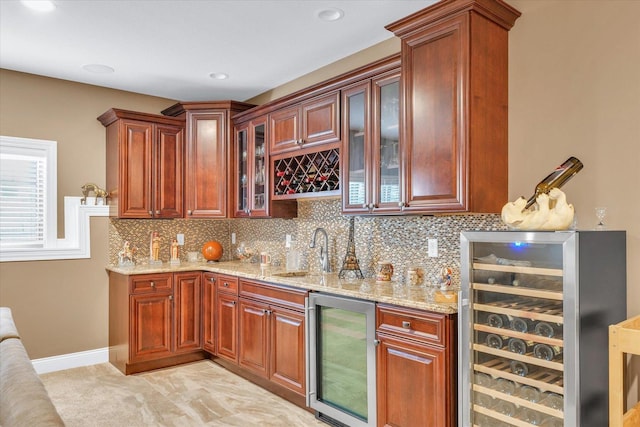 bar with light stone countertops, wine cooler, tasteful backsplash, and sink