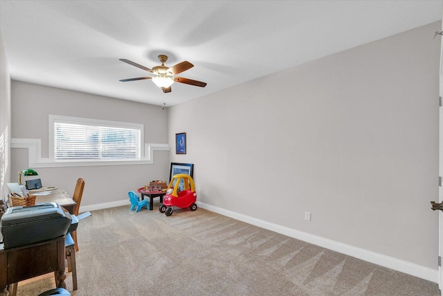 playroom with ceiling fan and carpet flooring