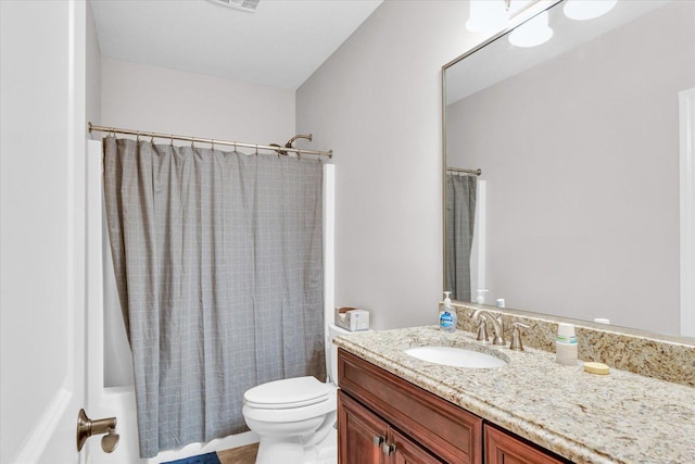 full bathroom with toilet, vanity, and shower / bath combo with shower curtain