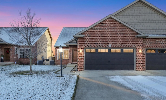 view of front of property with a garage and central AC unit