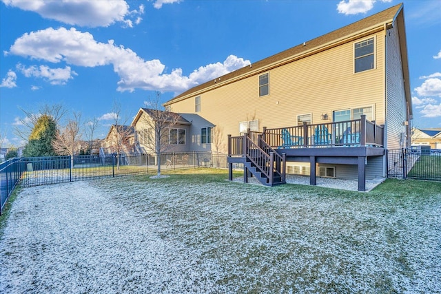 back of house featuring a wooden deck and a lawn