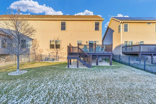 back of house featuring a yard and a deck