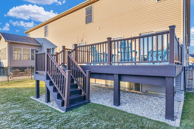 back of house with a wooden deck and a lawn