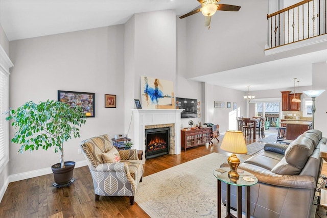 living room with ceiling fan, dark hardwood / wood-style flooring, and high vaulted ceiling