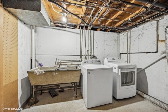 washroom with washer and clothes dryer and sink