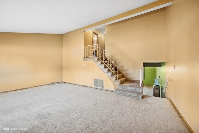 unfurnished living room featuring carpet