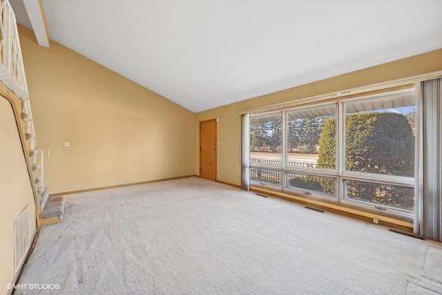 interior space with light carpet and lofted ceiling