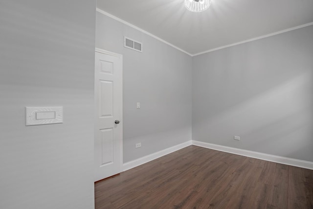 spare room featuring dark hardwood / wood-style flooring and ornamental molding