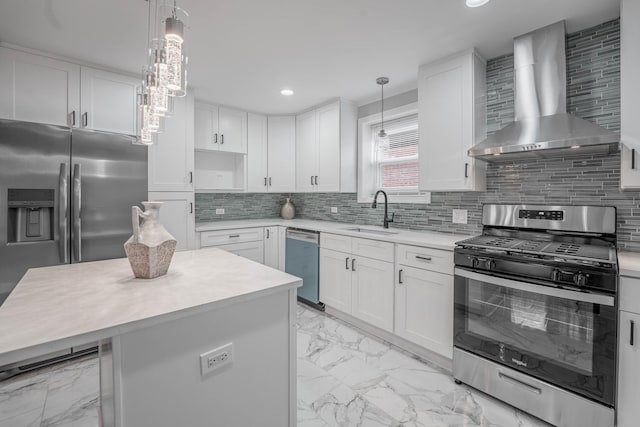 kitchen featuring white cabinets, a kitchen island, wall chimney exhaust hood, and appliances with stainless steel finishes