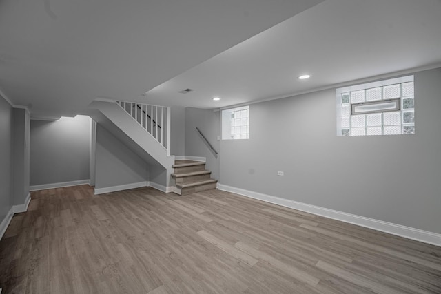 basement with light wood-type flooring and plenty of natural light