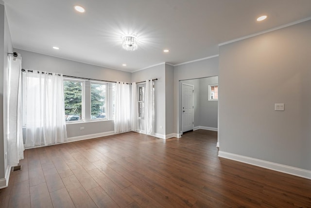 spare room with dark hardwood / wood-style floors and ornamental molding