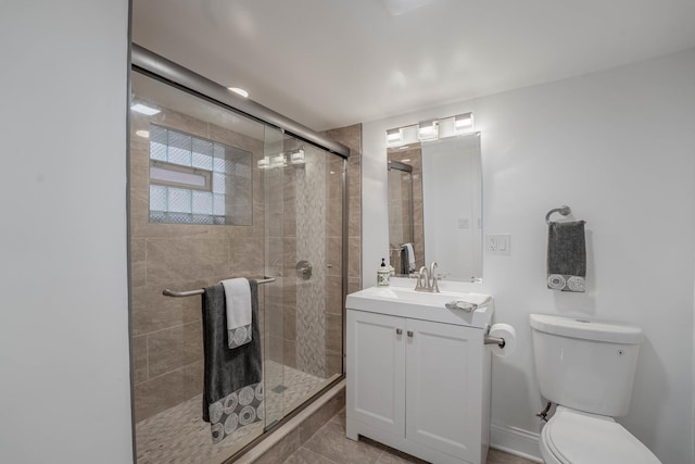 bathroom with tile patterned flooring, vanity, toilet, and walk in shower