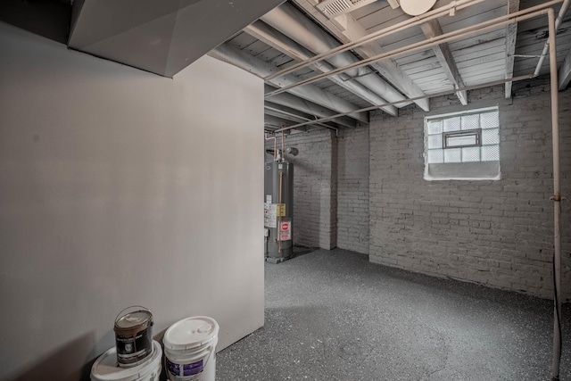 basement featuring brick wall and gas water heater