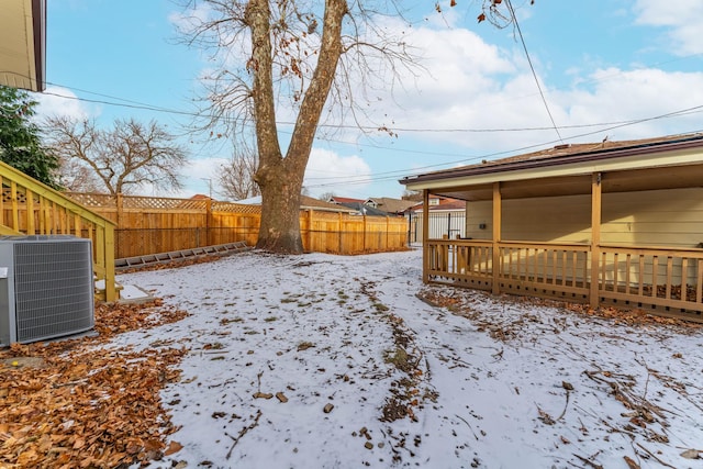 snowy yard featuring central air condition unit