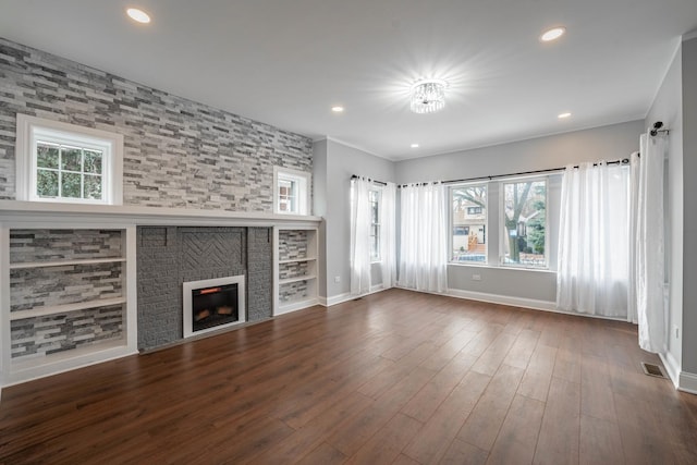 unfurnished living room featuring dark hardwood / wood-style flooring and a fireplace