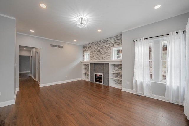 unfurnished living room featuring dark hardwood / wood-style flooring and a tiled fireplace