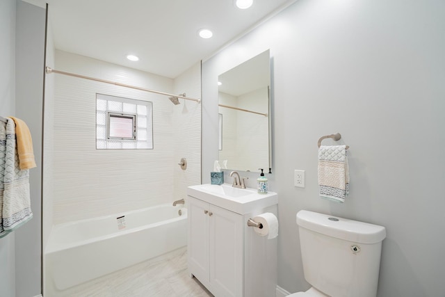 full bathroom featuring vanity, tiled shower / bath combo, and toilet