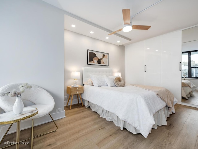 bedroom featuring light hardwood / wood-style flooring and ceiling fan