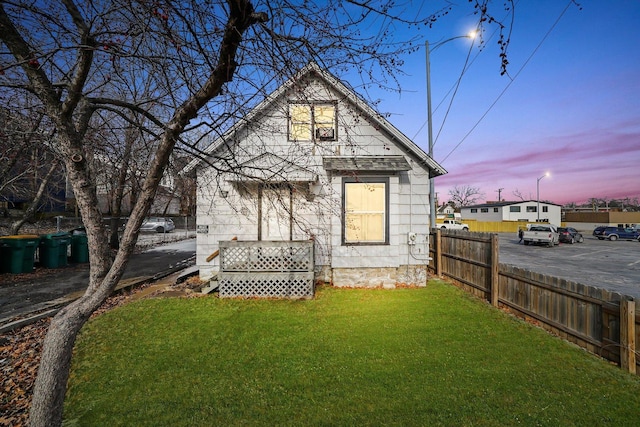 back house at dusk with a yard