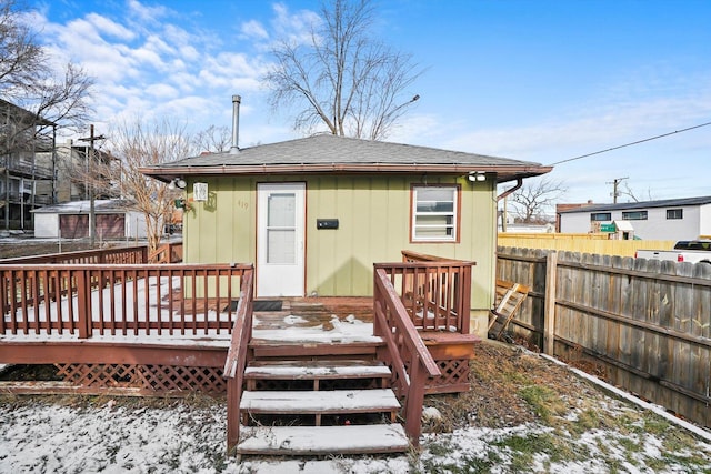 snow covered property featuring a deck