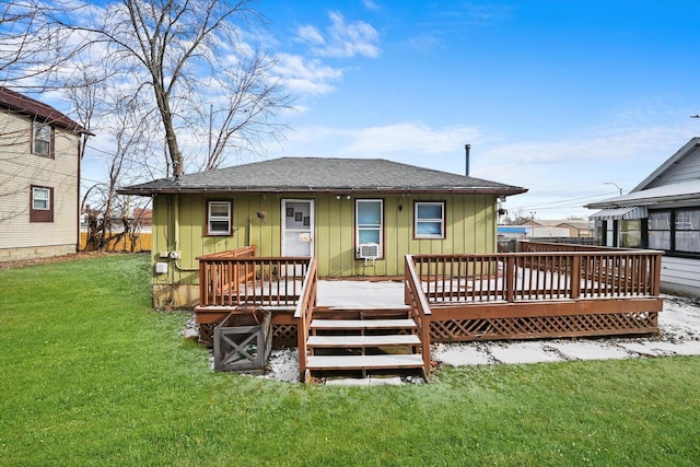 rear view of house featuring a deck and a yard