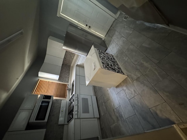 kitchen with decorative backsplash and white cabinetry