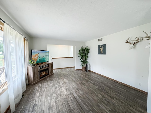 unfurnished living room featuring dark wood-type flooring