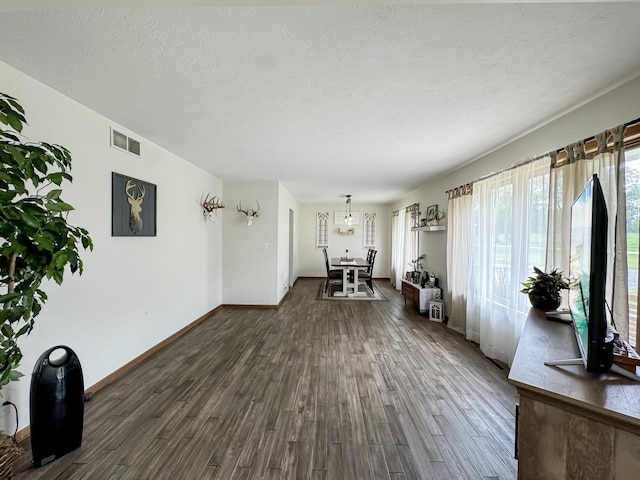 interior space with dark hardwood / wood-style floors and a textured ceiling