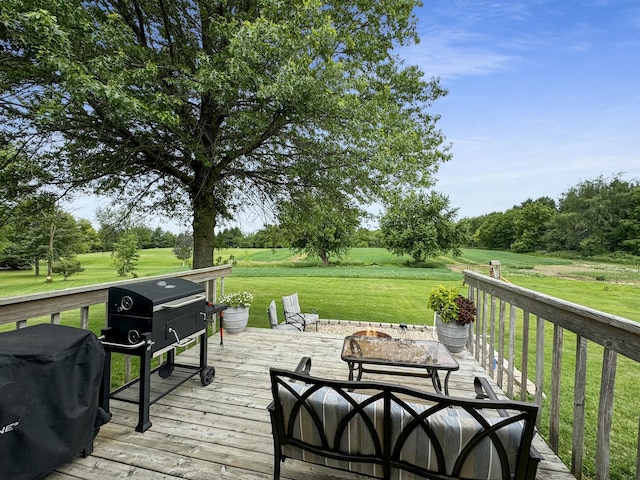 wooden terrace with a lawn and a grill