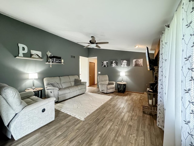 living room featuring hardwood / wood-style floors and ceiling fan