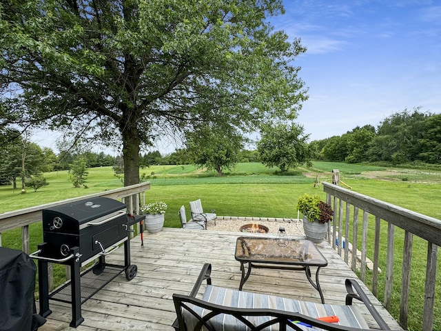 wooden terrace featuring grilling area, a yard, and an outdoor fire pit