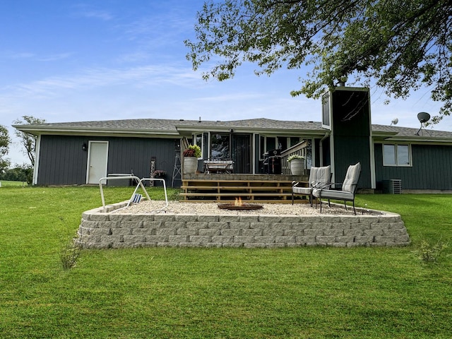 rear view of house featuring a lawn and a deck