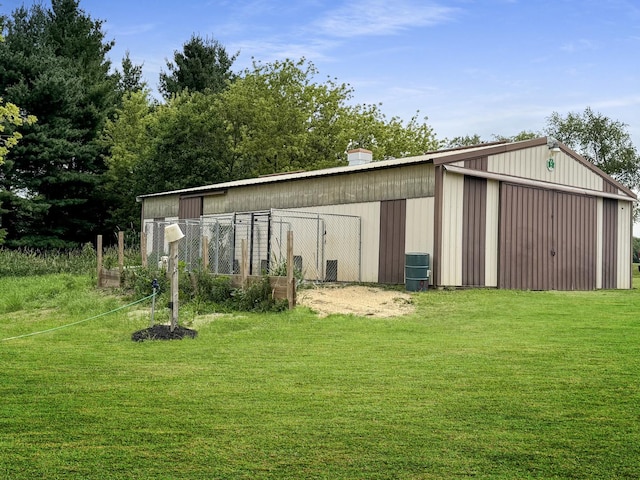 view of outbuilding featuring a yard