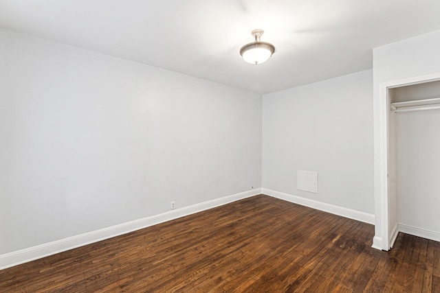 unfurnished bedroom featuring dark hardwood / wood-style flooring and a closet