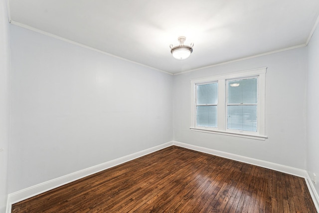 spare room with dark hardwood / wood-style flooring and ornamental molding