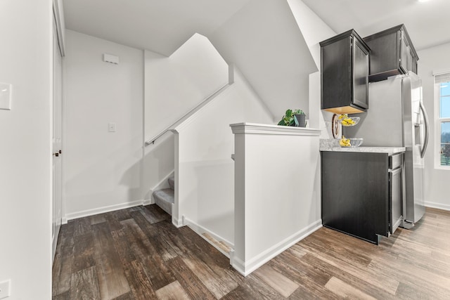 staircase with hardwood / wood-style flooring