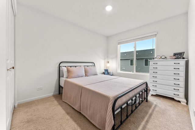 bedroom featuring light colored carpet