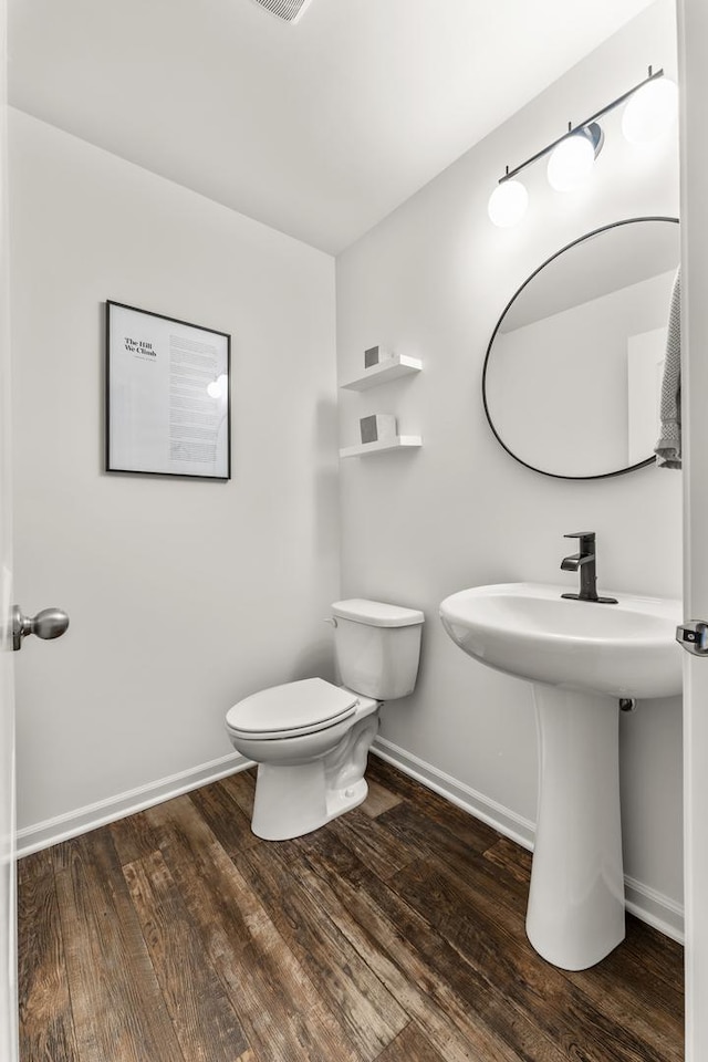 bathroom featuring hardwood / wood-style floors and toilet