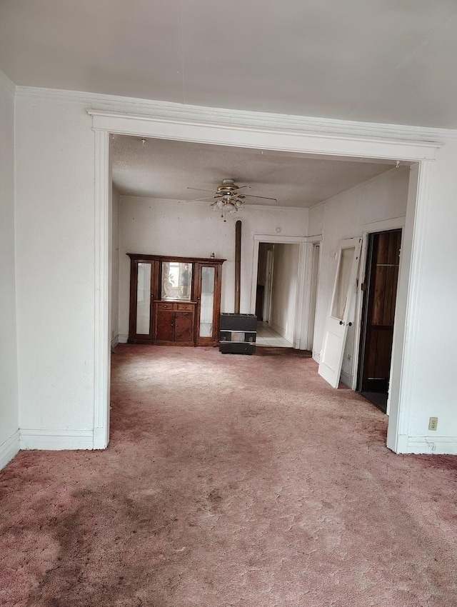 unfurnished living room featuring ceiling fan and carpet floors