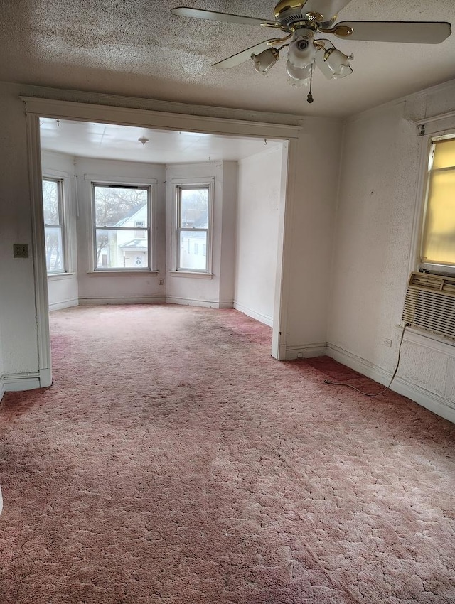 carpeted empty room featuring a textured ceiling, ceiling fan, and cooling unit