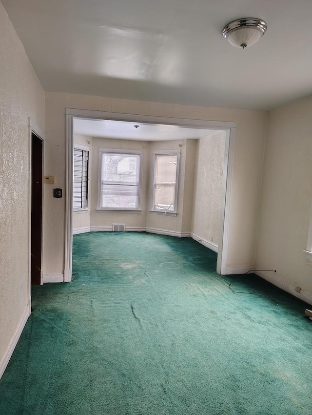 empty room featuring dark colored carpet