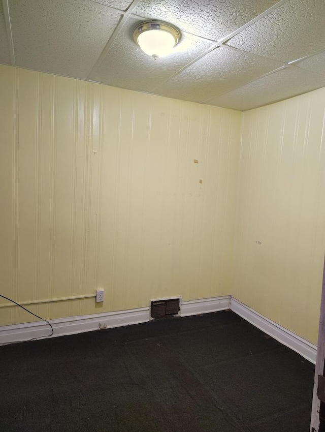 unfurnished room featuring a paneled ceiling