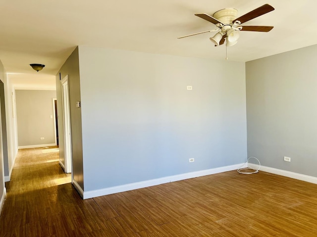 unfurnished room with ceiling fan and dark wood-type flooring