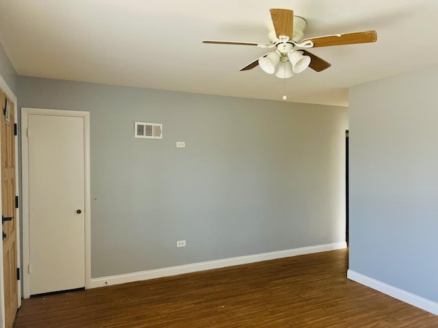 spare room with ceiling fan and dark hardwood / wood-style floors